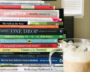 Image of several books and a coffee mug