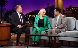 James Corden talking with multiple guests on his show.